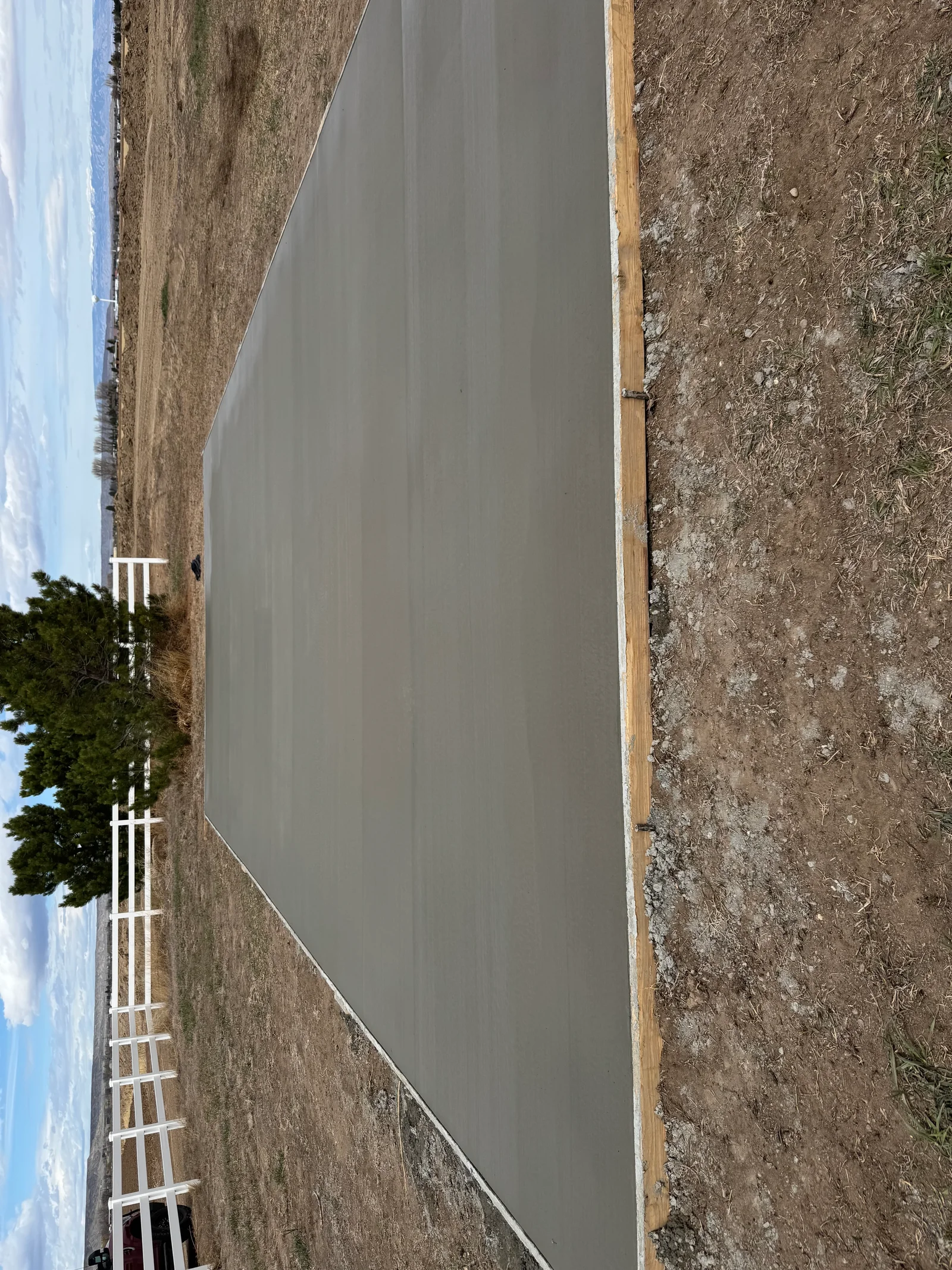 New concrete driveway with wooden edge forms and prepared base material