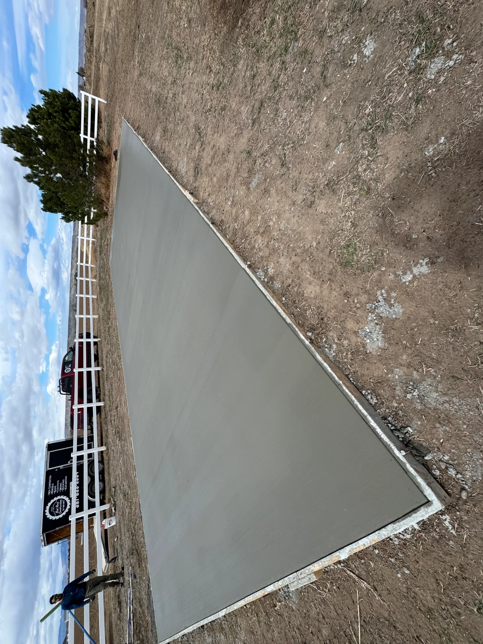 Newly poured concrete driveway with finished edges and proper grading