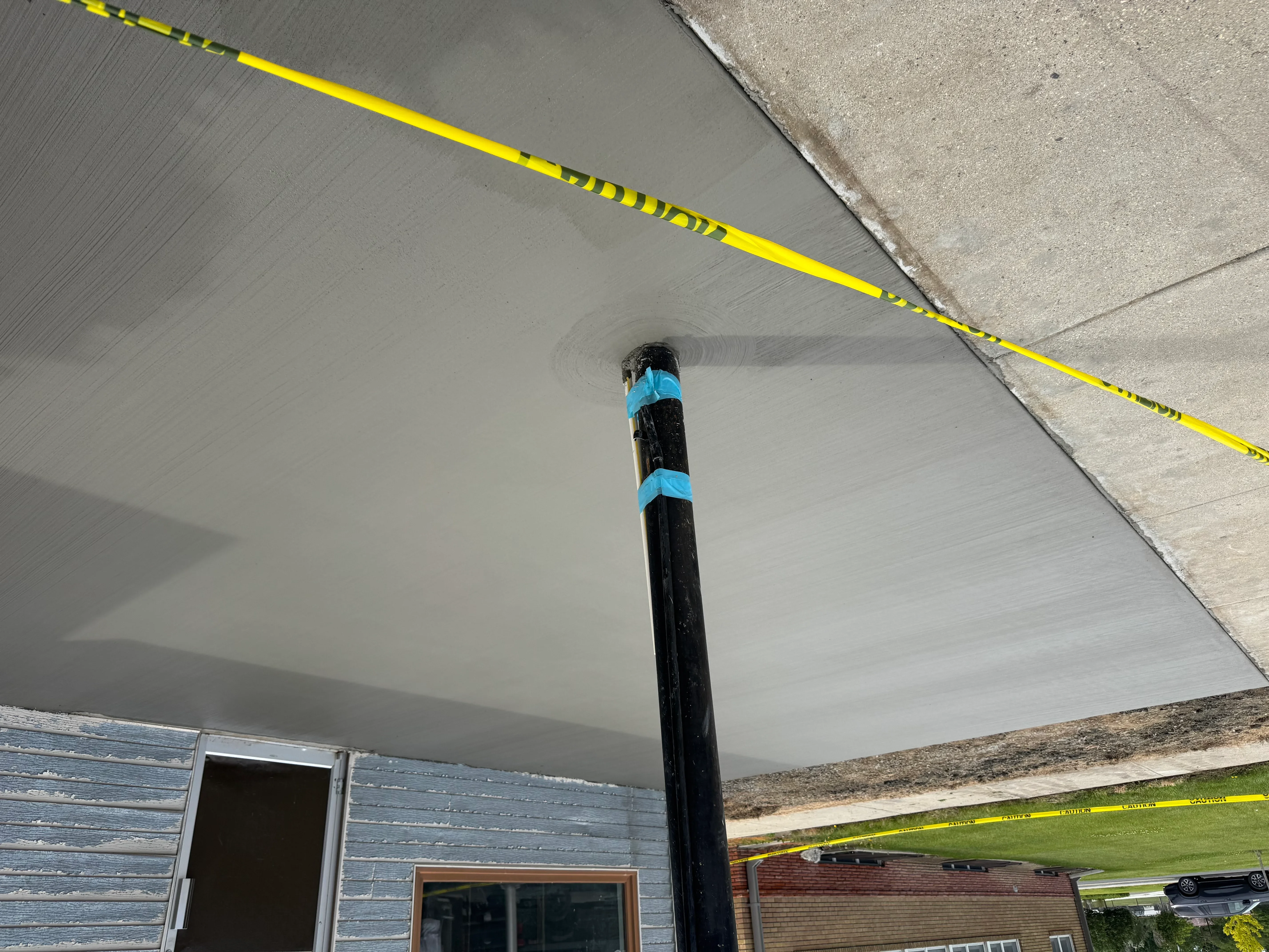 Finished drywall ceiling with smooth taping and mudding, black support column with blue bands